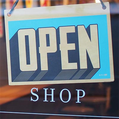 Image of a store's open for business sign.